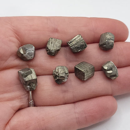 Raw pyrite crystals in a hand to choose from for raw pyrite necklace