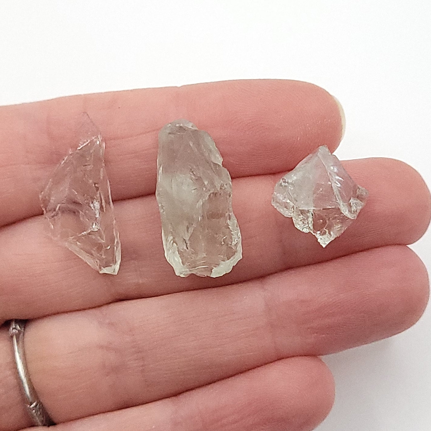 3 pieces of raw prasiolite in hand to choose from for raw prasiolite necklace in copper