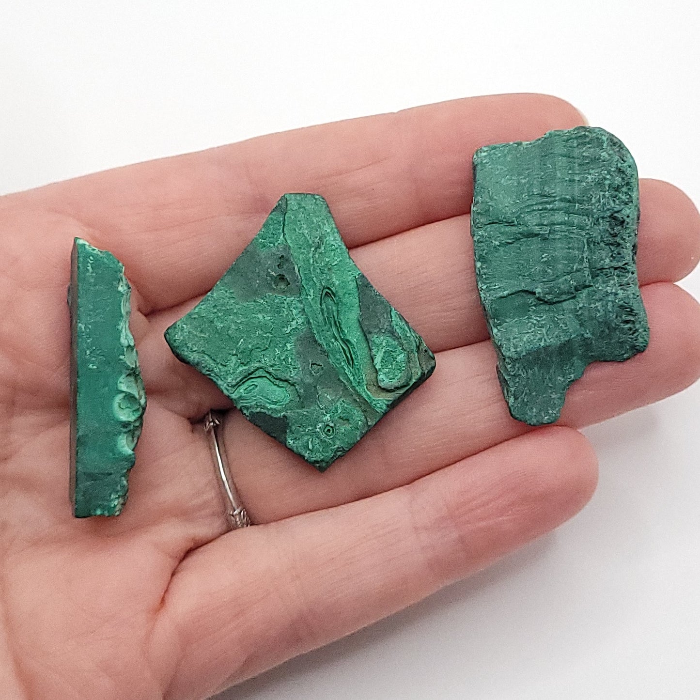 3 raw malachite in hand to choose from for raw malachite necklace