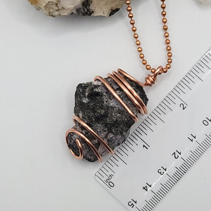 raw mystic merlinite necklace in copper wire on a copper ball chain next to ruler , measuring just over 2 inches