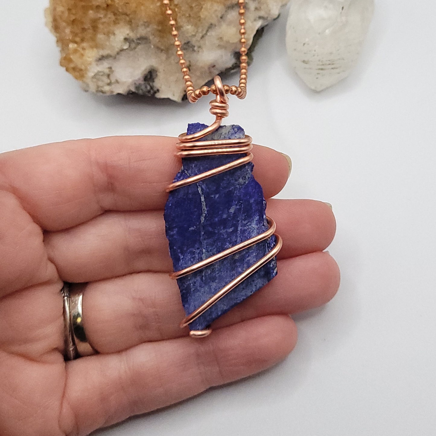 lapis lazuli necklace in copper wire on a copper ball chain in hand