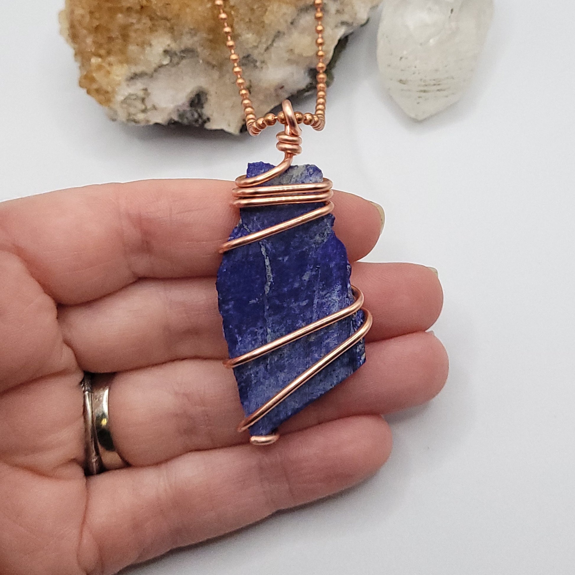 lapis lazuli necklace in copper wire on a copper ball chain in hand