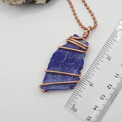 lapis lazuli necklace in copper wire on a copper ball chain next to ruler , measuring about 2.5 inches