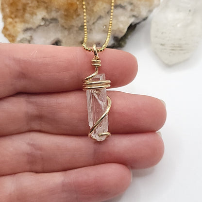 Raw Danburite Necklace in Gold in hand