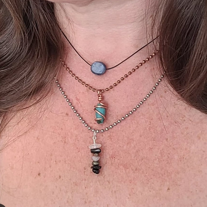 adjustable blue kyanite necklace on model, layered with a copper and silver necklace