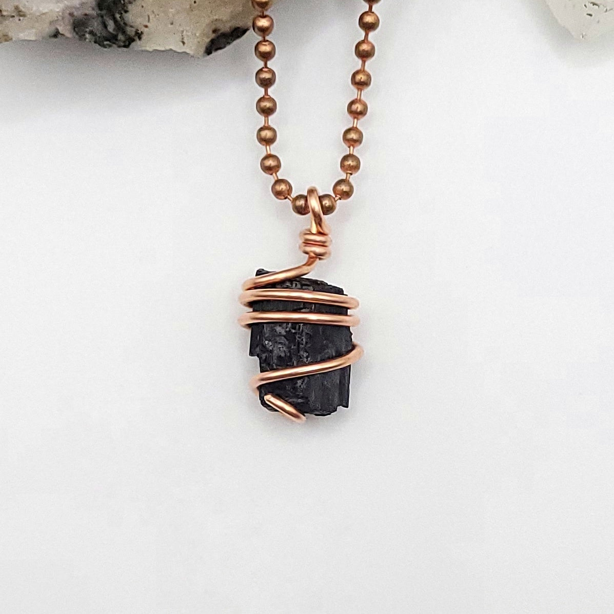 raw black tourmaline necklace in copper on white background