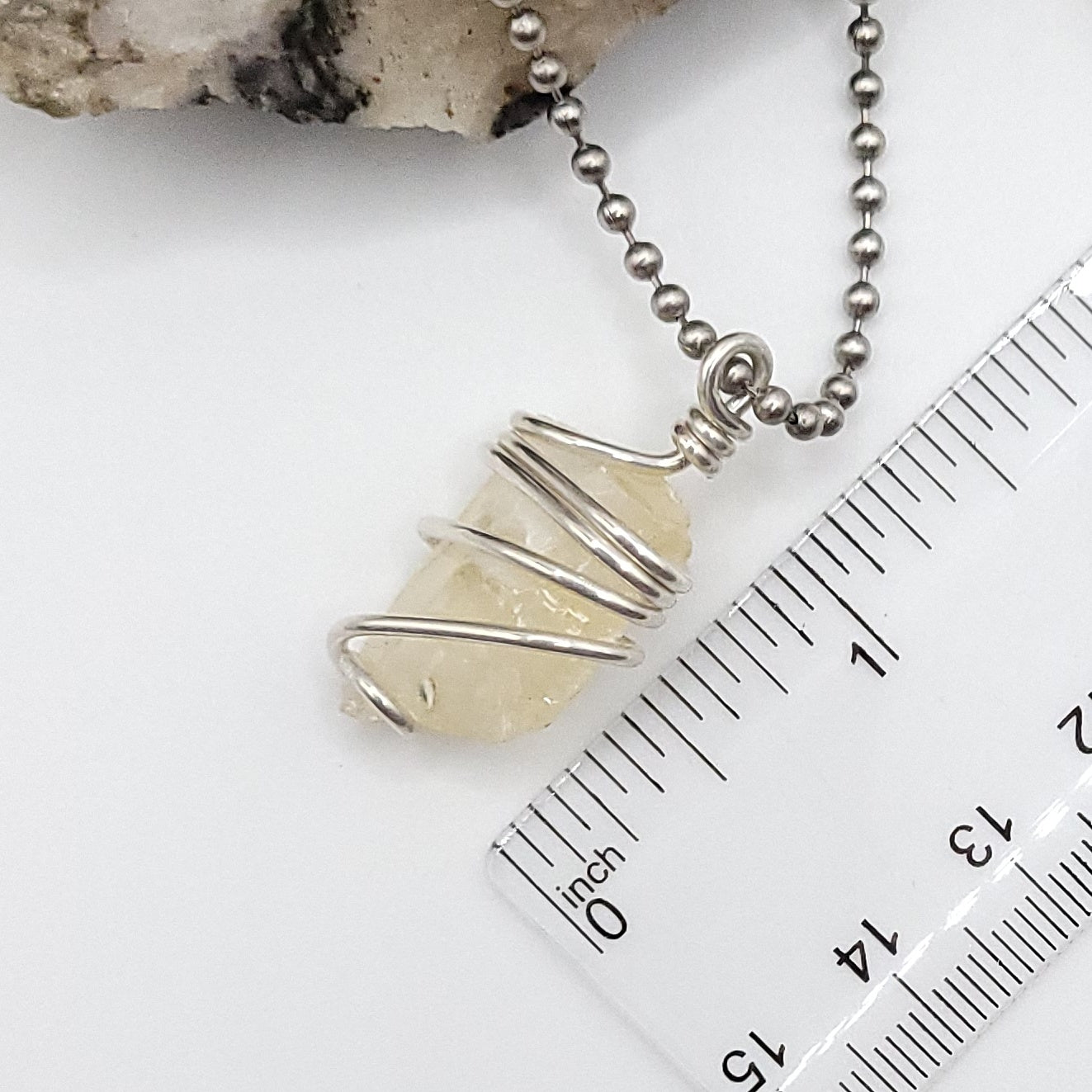 Raw Honey Calcite Necklace in Silver showcased with measuring ruler for scale.