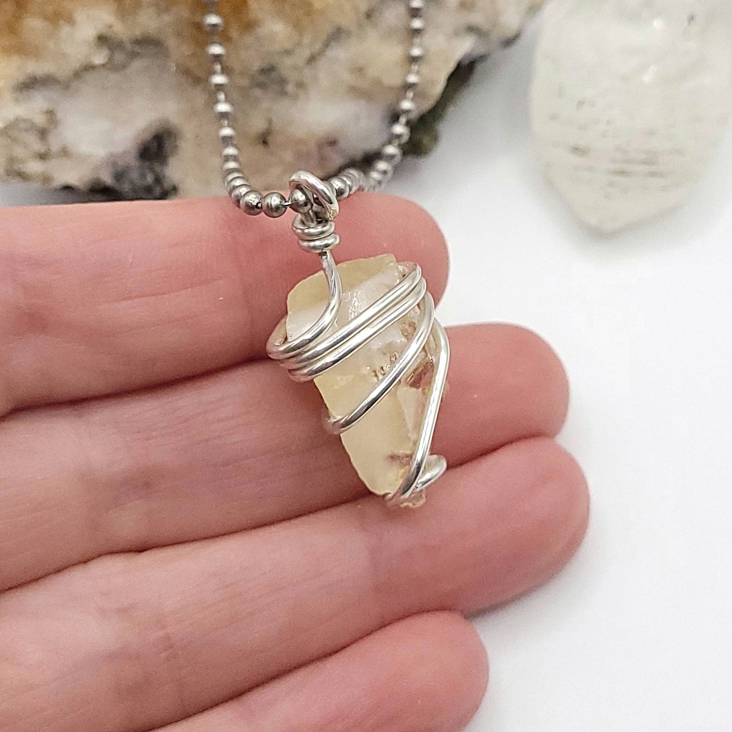Raw Honey Calcite Necklace in Silver showcasing authentic raw calcite wrapped in sterling silver wire.