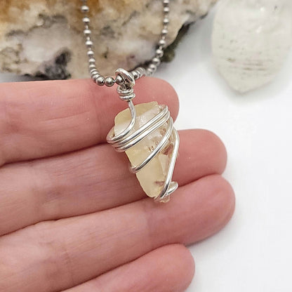 Raw Honey Calcite Necklace in Silver showcasing authentic raw calcite wrapped in sterling silver wire.