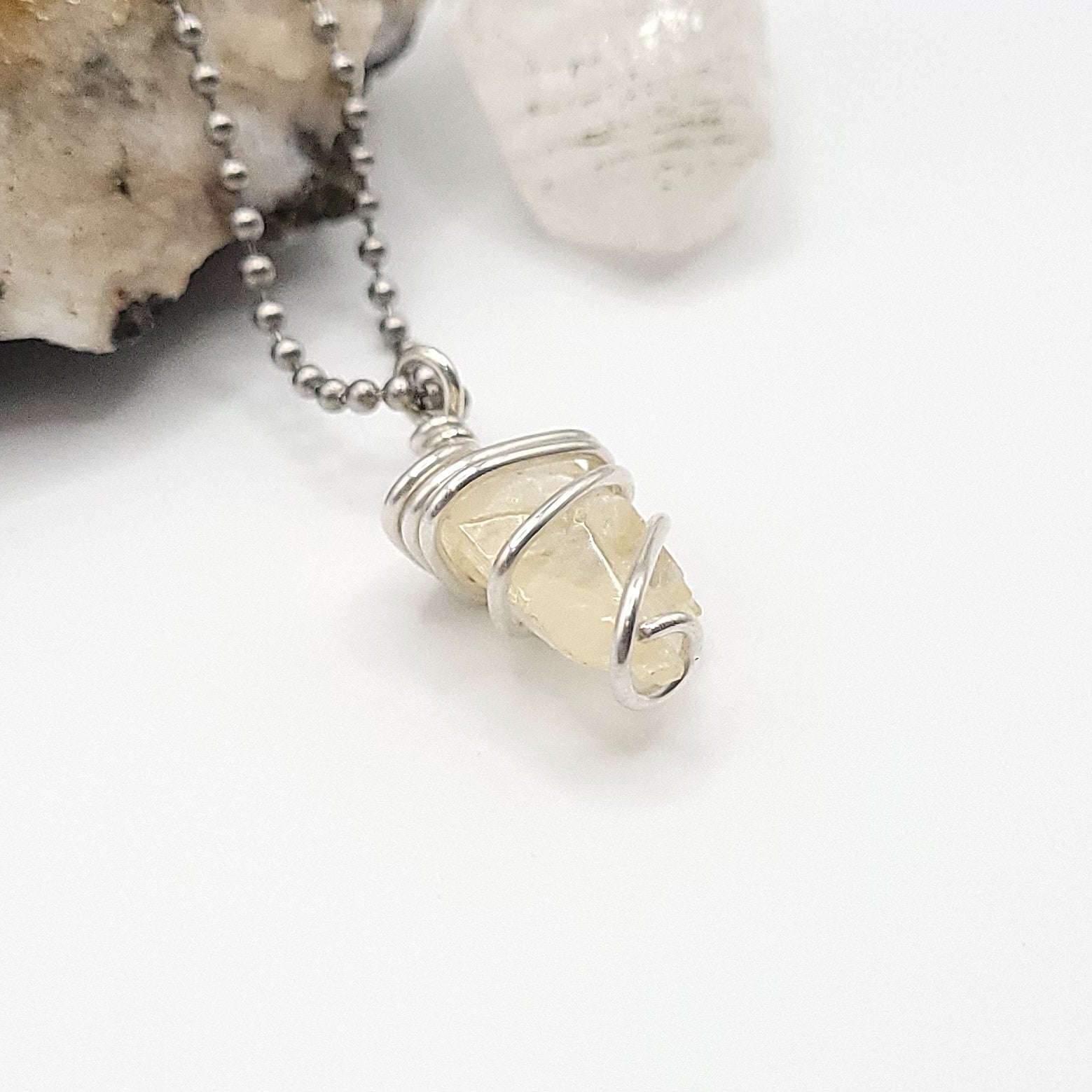 Raw Honey Calcite Necklace in silver wire with a raw yellow stone to boost confidence and motivation.