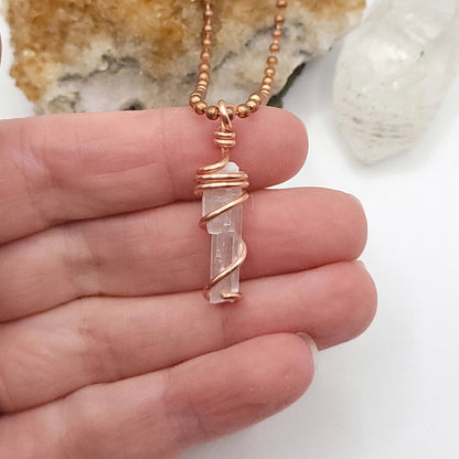 raw selenite necklace in copper wire in hand