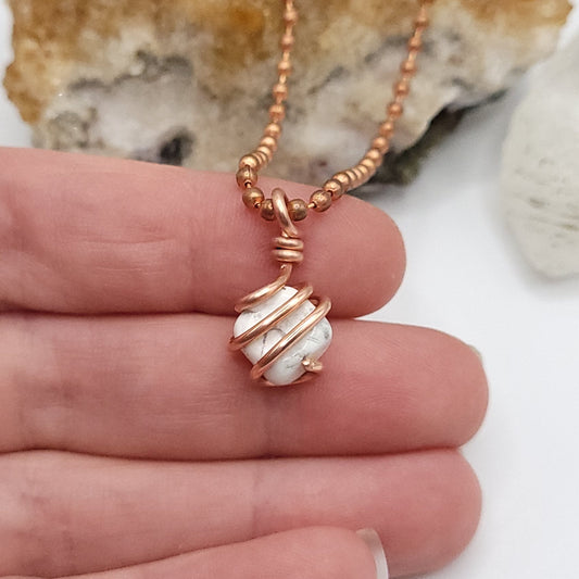 howlite necklace in copper wire in hand