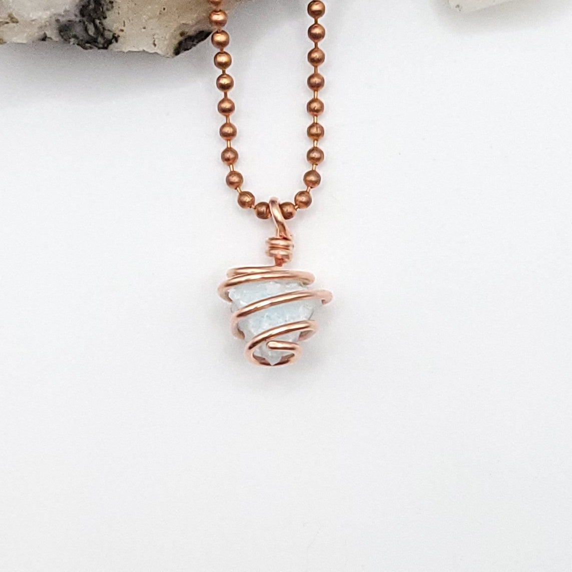 raw blue aragonite necklace in copper wire on a ball chain, promoting inner peace and balance.