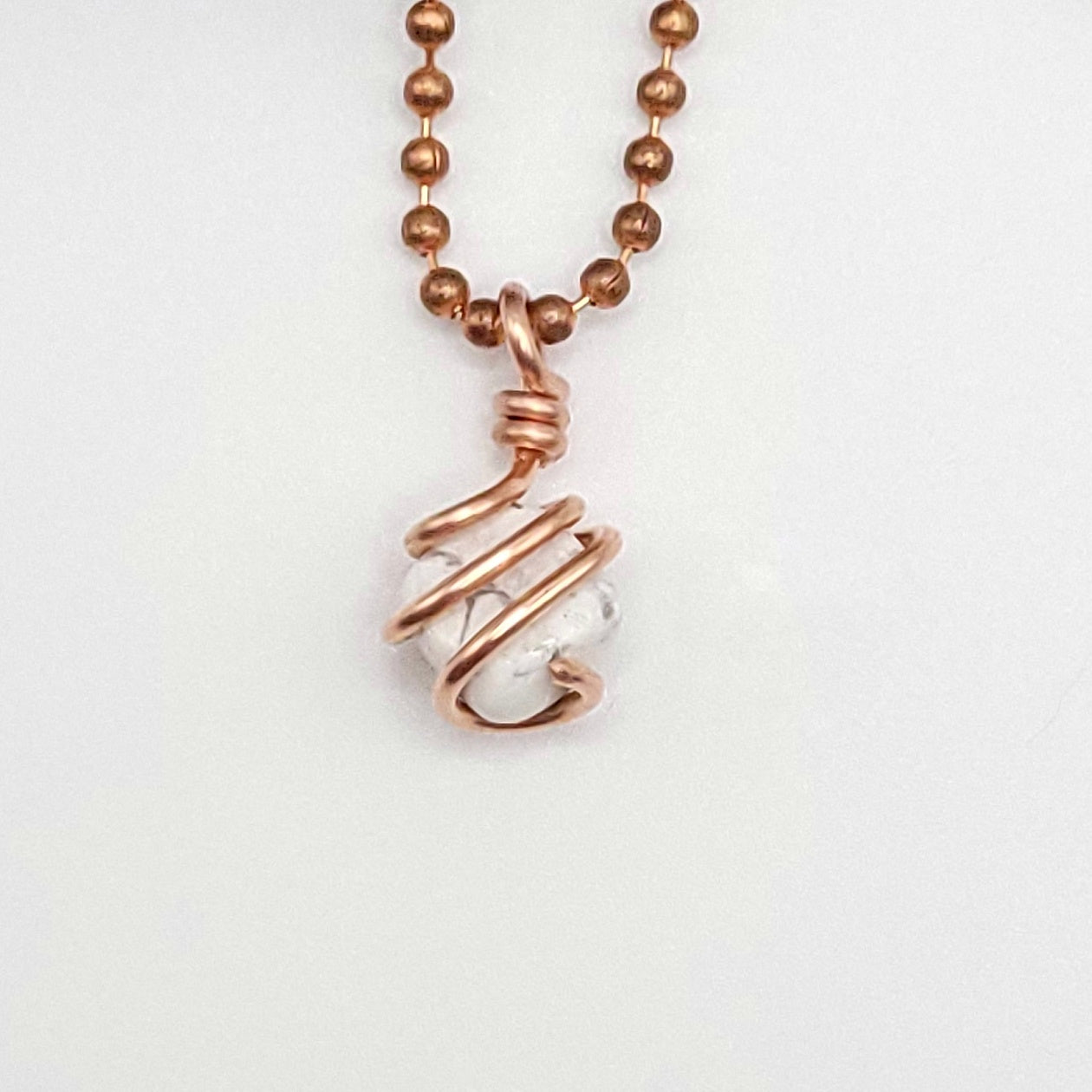 howlite necklace in copper wire in hand close up