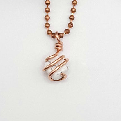 howlite necklace in copper wire in hand close up
