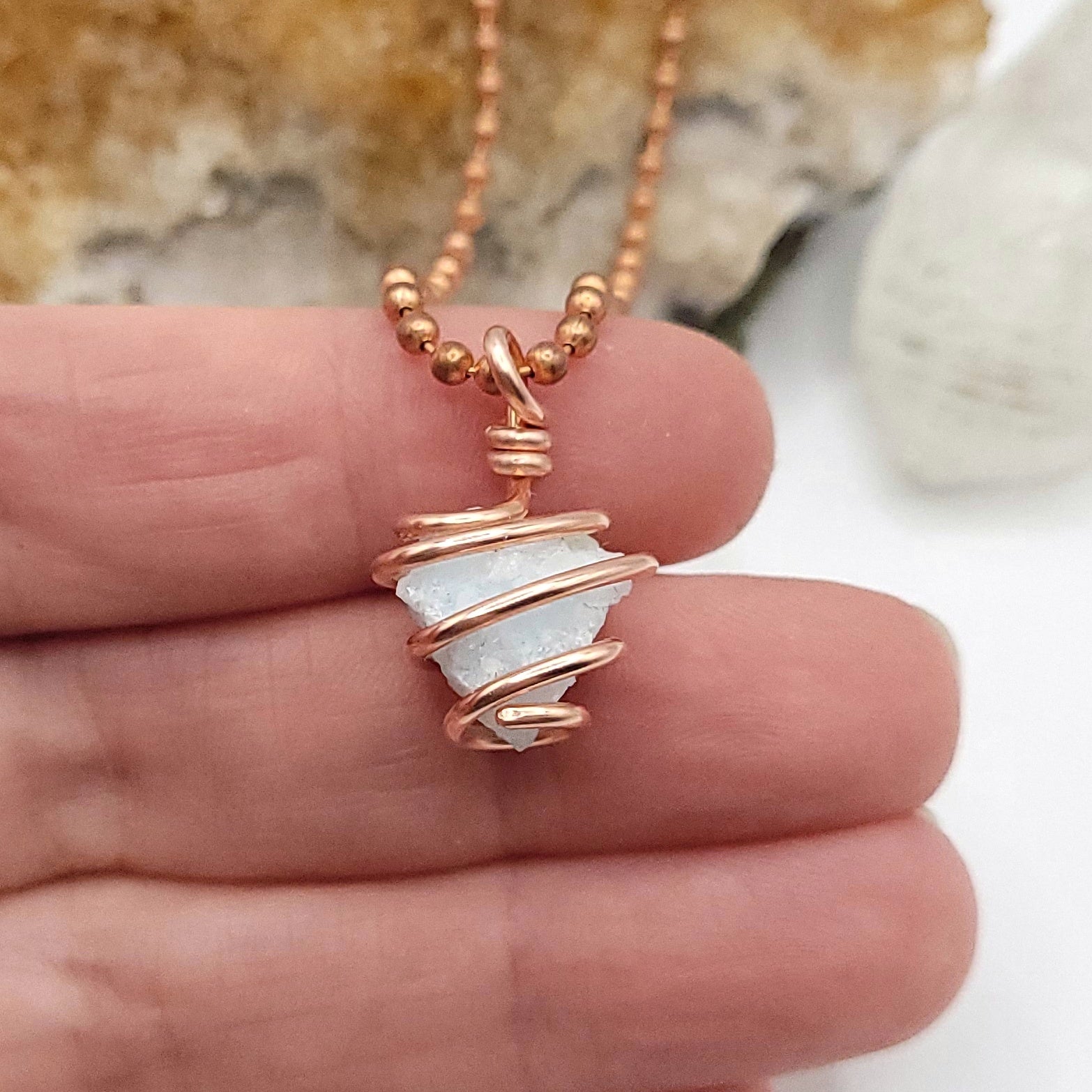 Raw blue aragonite necklace in copper wire, showcasing soothing energy for inner peace.