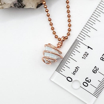 Raw blue aragonite necklace in copper wire, showcasing soothing energy and balance.
