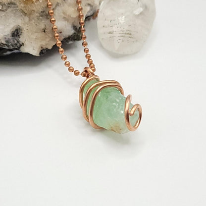Raw green calcite necklace in copper showcasing soothing vibes and heart healing properties.